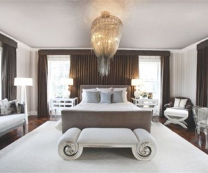 The Barlas Baylar chandelier from Hudson Furniture casts a delicate shadow on the wal...