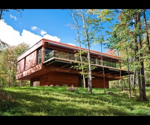 This contemporary green residence looks to be an amazing adventure for children and grown-up Tarzans and Janes. Located among the pristine pine and hardwood forests in the Eastern Townships within the community of Sanctuaire Mont-Cathédrale, this tree house-inspired home has 3000 sq. ft. of living space on six acres of land with amazing views of Lake Brompton and private lake access.