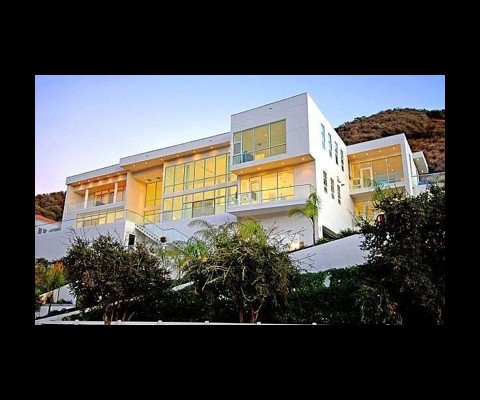 The home, which was listed on Redfin, was completed in 2007, boasts 6 bedrooms and 9 baths, and comes with a $3,995,000 sticker. Crafted with a sartorial take on outer-space style, the home sports sleek lines, metal detailing and a monochromatic color palette 