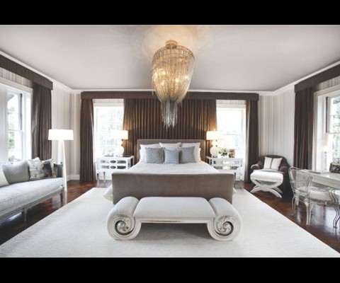 The Barlas Baylar chandelier from Hudson Furniture casts a delicate shadow on the wall above the Allan Knight bed and the Christopher Guy bench at its foot, in the master. Automated drapes crafted from Donghia fabric with Samuel & Sons trim ensure privacy at any time of day. 