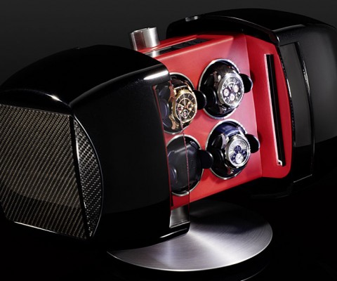 The aluminum case is inlaid with your choice of high-tech carbon fiber or high-polished Makassar ebony for a strikingly sleek unit worth displaying. The interior is appointed with Italian leather and an LED lighting system, while a German lock keeps your collection secure. 